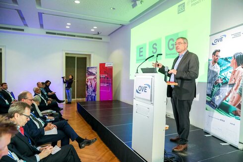 Ein Redner präsentiert zum Thema ESG vor Publikum auf einer Veranstaltung.