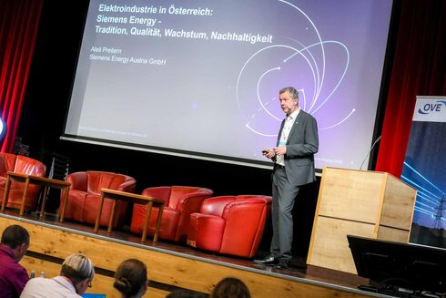 Mann spricht auf einer Konferenz über Siemens Energy und Elektronikindustrie in Österreich.